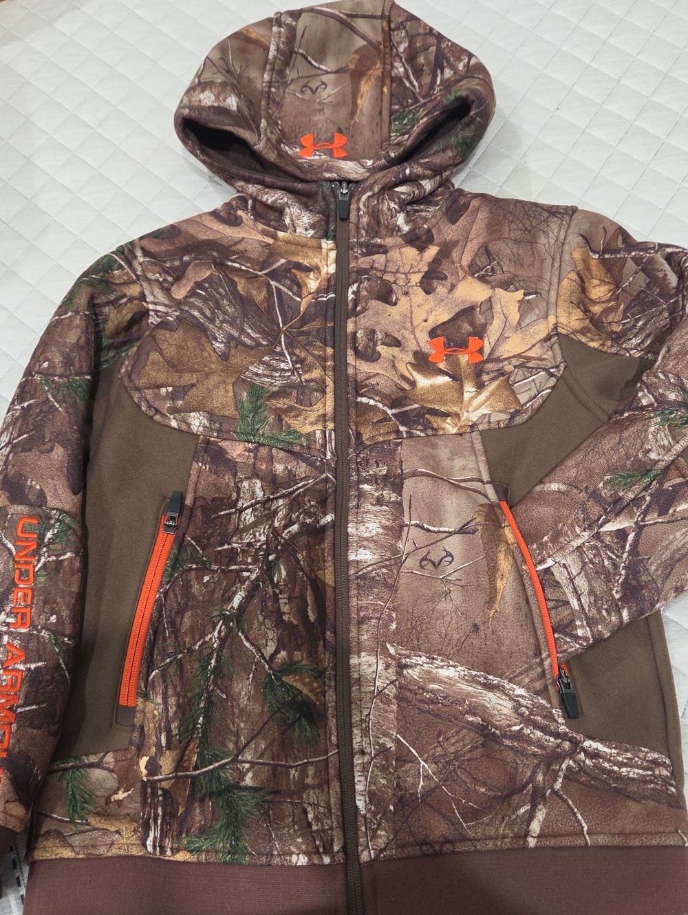 UA Realtree Brown Camo Hooded Performance KIDS Jacket with Orange Accents.